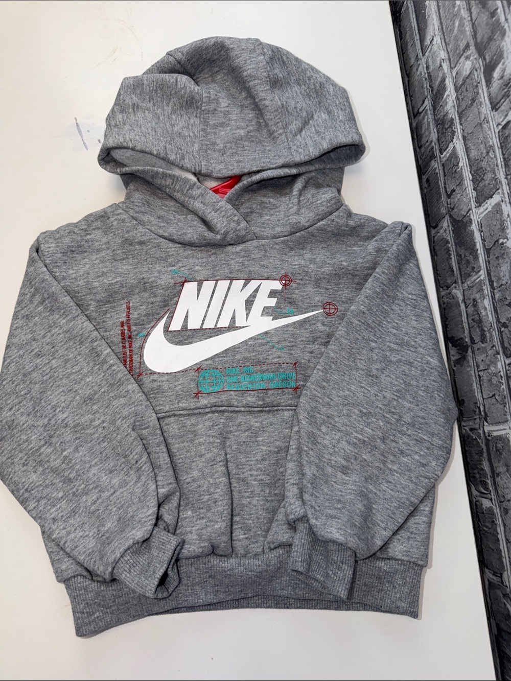 Nike Grey Kids Hoodie with White Logo and Teal Accents